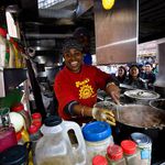Fauzia Abdur-Rahman from Fauzia's Delights (161st St and Sheridan Ave in The Bronx) stirring up some jerk chicken.
